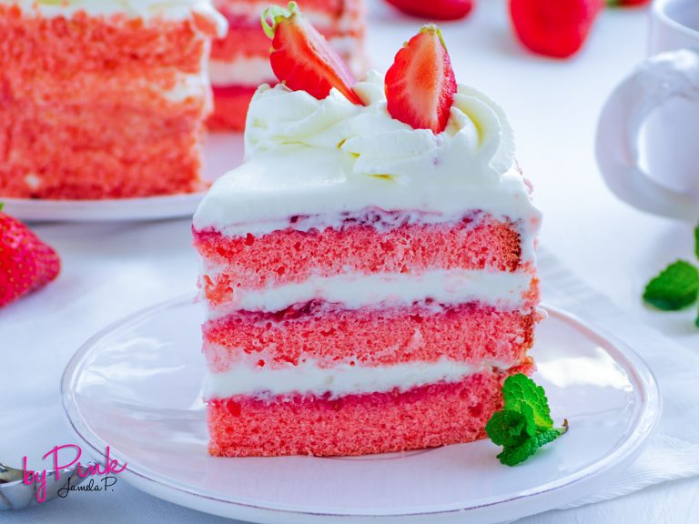strawberry Cake with strawberries white icing and strawberry jam.