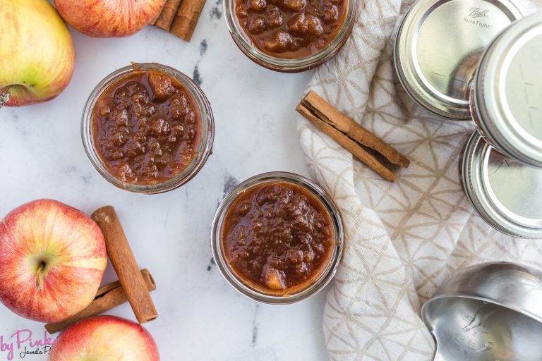 top view of apple jam recipe in mason jars with apples and cinnamon sticks