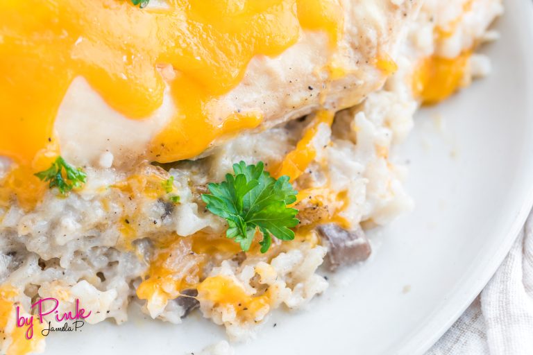 close up of creamy chicken and rice on a white plate