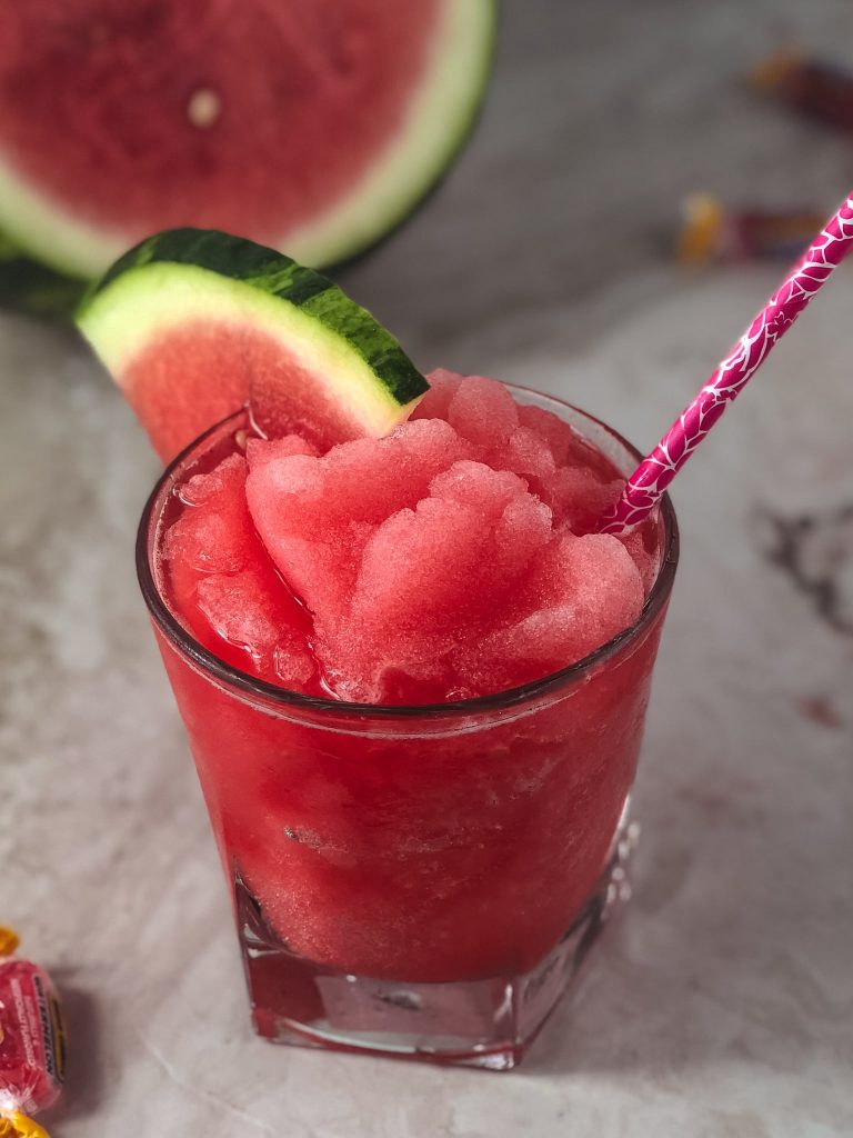 If you are a fan of the watermelon and jolly rancher, then you will swoon over this watermelon jolly rancher infused frozen margarita. Cool off on a hot summer day with this frozen margarita that is bursting with watermelon flavor. #summercocktails #cocktail #tequila