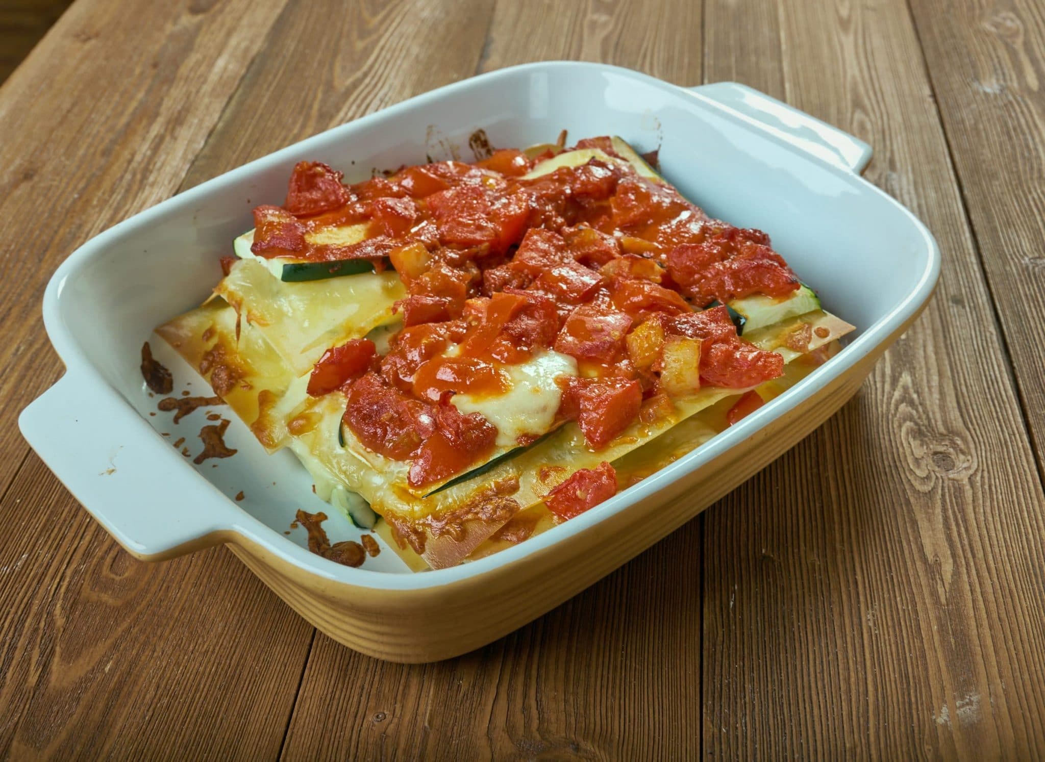 Zucchini Lasagna top side view in a tan casserole dish
