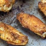 angeled side view of air fryer chicken wings keto on an old baking sheet
