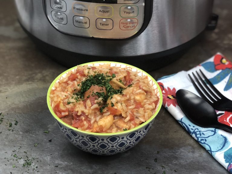small bowl with instant pot jambalaya utinsils on a napkin with an instant pot in the background