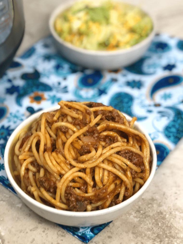This one-pot Instant Pot Spaghetti will amaze you with the beautiful blend of flavors and ease of cooking. No more having a pot of boiling water for noodles, pan for meat sauce, and a ton of dirty dishes. #instantpot #spaghetti #pasta #noodles