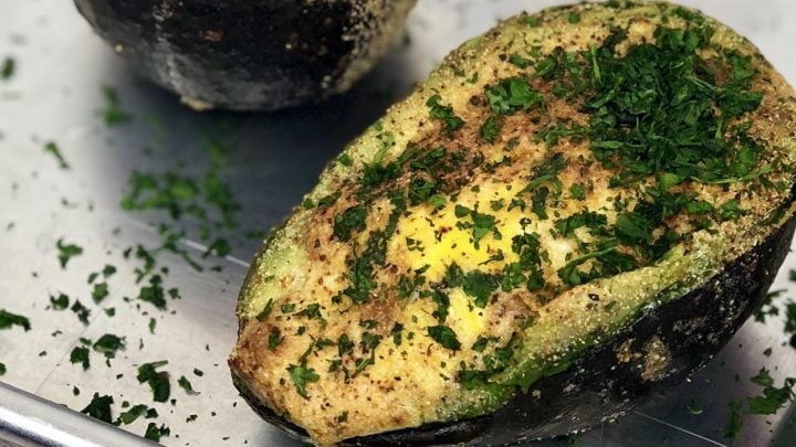 Air Fryer Baked Avocado Egg. Is what dreams are made of. A stuffed avocado filled with an egg and seasonings that make a perfectly healthy breakfast. And bonus, this avocado egg is low carb and keto! #lowcarb #keto #avocado #egg #airfryer