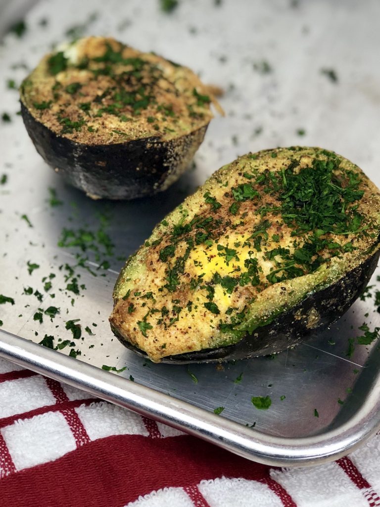 Air Fryer Baked Avocado Egg. Is what dreams are made of. A stuffed avocado filled with an egg and seasonings that make a perfectly healthy breakfast. And bonus, this avocado egg is low carb and keto! #lowcarb #keto #avocado #egg #airfryer