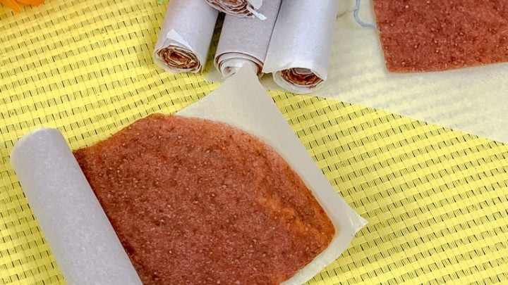 unrolling fruit roll up on a yellow placemat