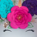 diy of unicorn wall decal with real pink and purple flowers and gold accents