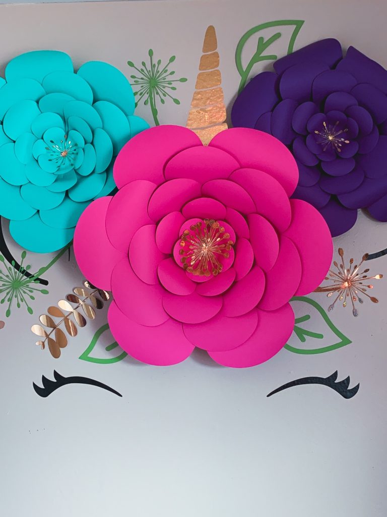 diy of unicorn wall decal with real pink and purple flowers and gold accents