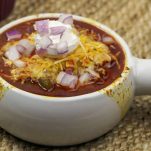white chili bowl with toppings in back
