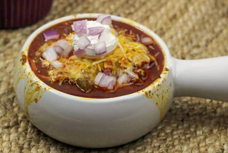 white chili bowl with toppings in back