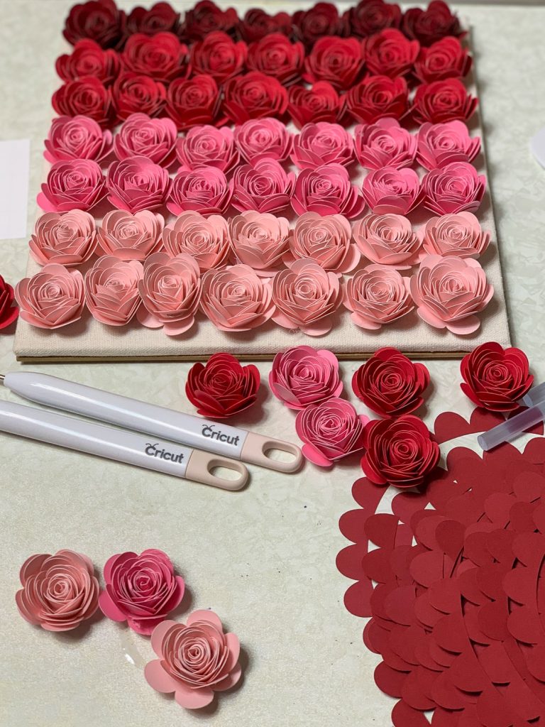 rolled paper flower lined up for ombre shadow pox in different shades of pink