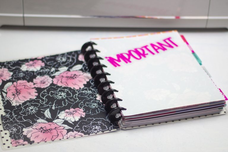 dollar tree binder with sticker on the plain side that says important cut into personal planner dividers for the happy planner