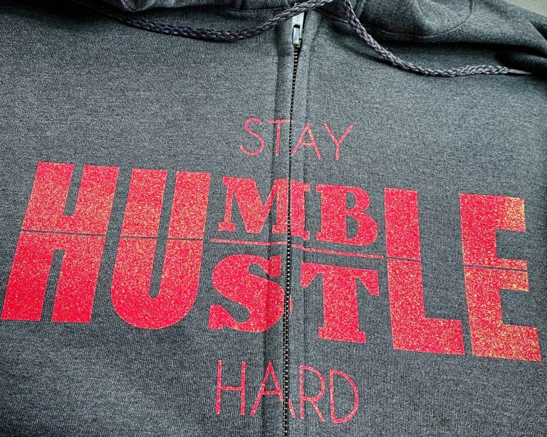 grey hoodie with a zipper with vinyl lettering