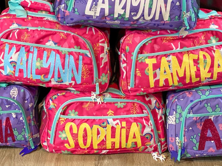 stacked duffle bags with vinyl lettering