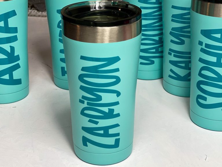 teal blue personalized coffee cups on a white table