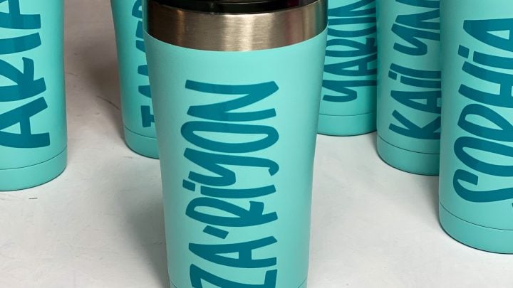 teal blue personalized coffee cups on a white table