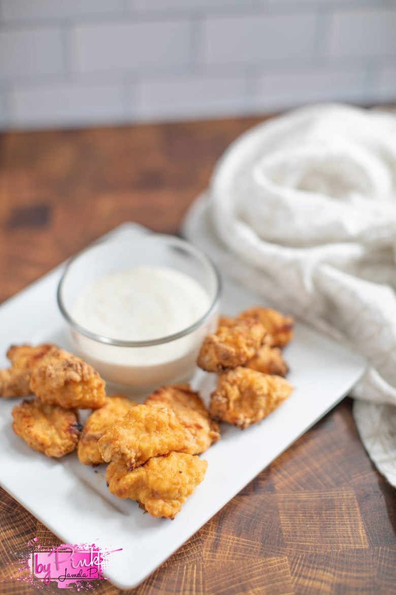 chick fil a nuggets air fryer chicken recipes on a white plate with ranch dressing