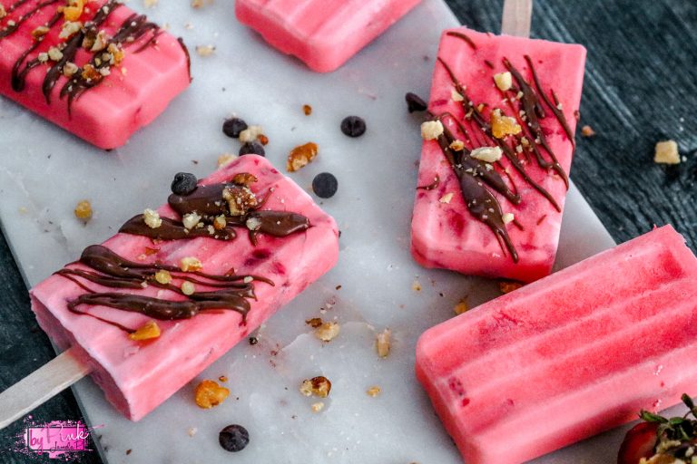 4 pink popsicles with a chocolate and walnut drizzle