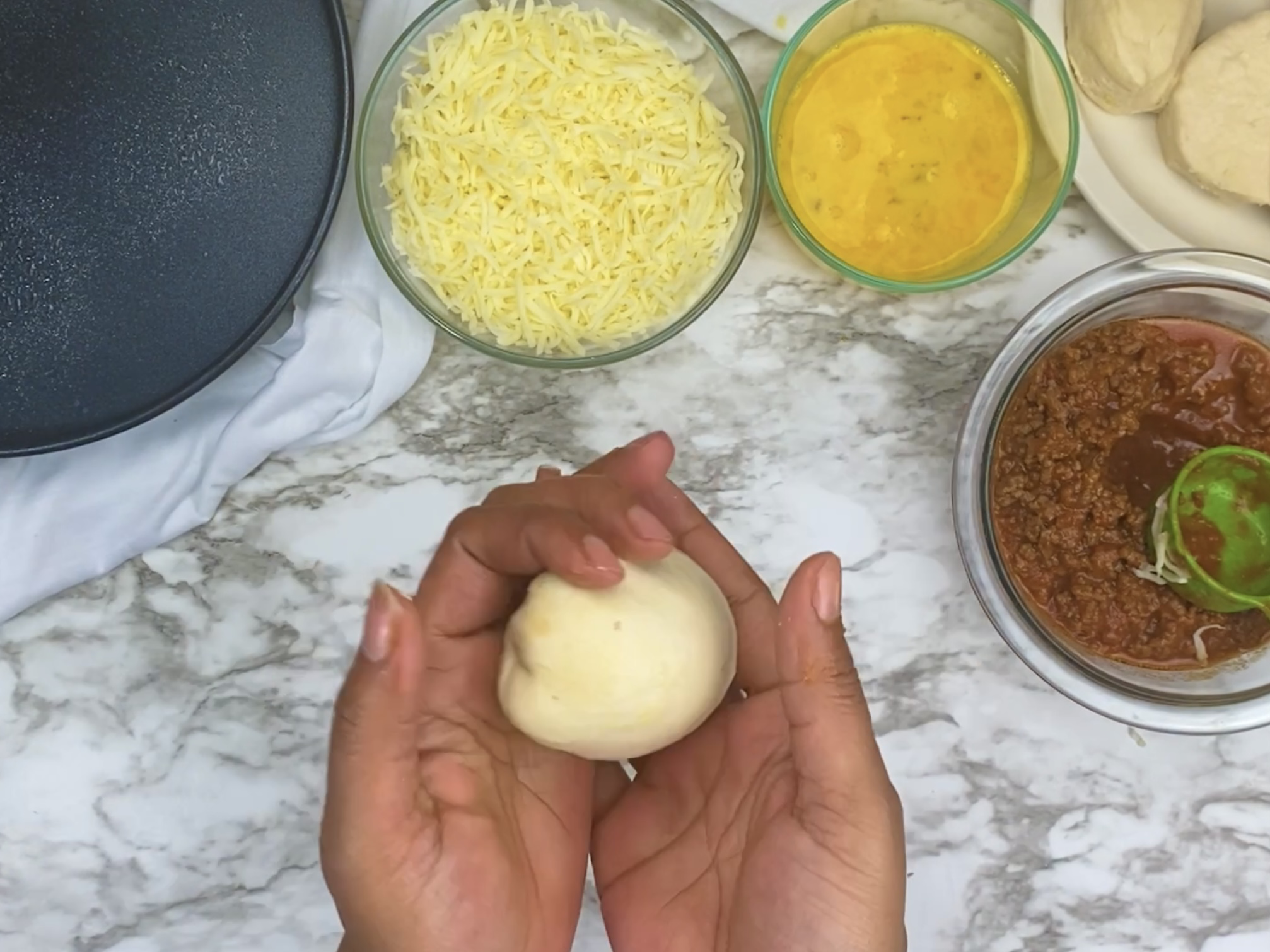 hands rolling dough into a ball