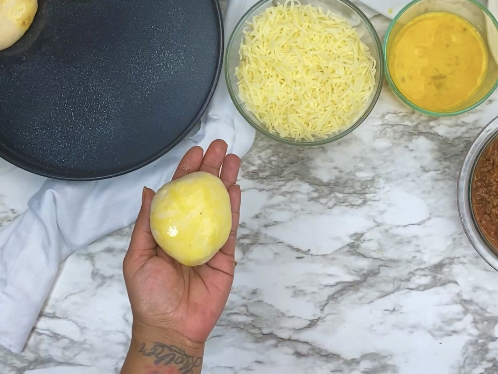 hand holding rolled sloppy joe bomb brushed with butter