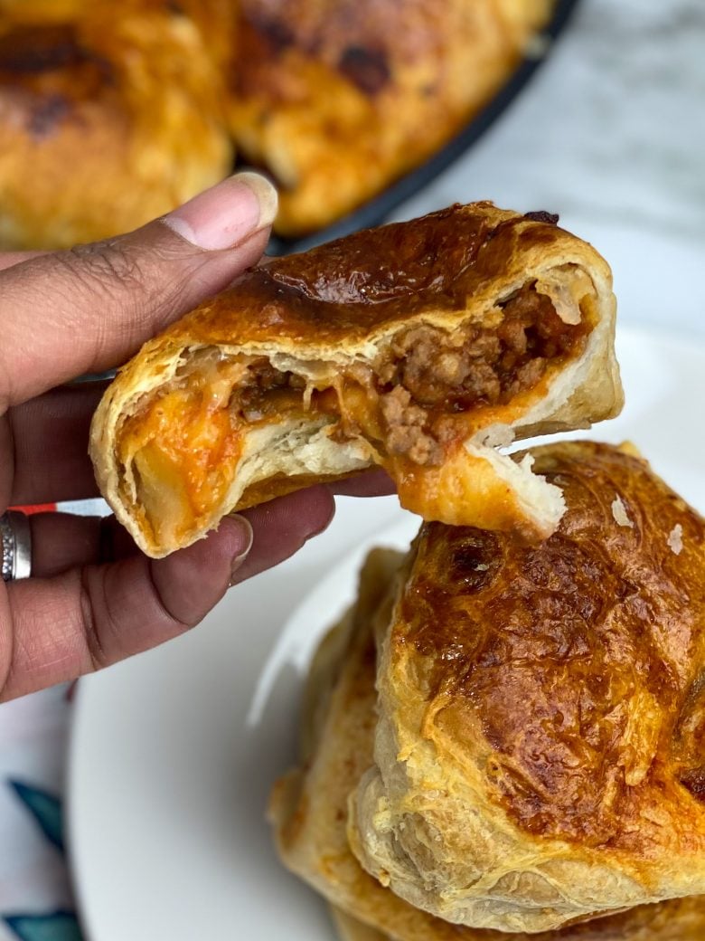 sloppy joe cut in half with ground beef and mozzarella cheese on the inside