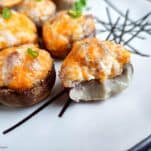 close up side view of cheddar stuffed mushrooms