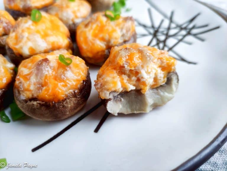 close up side view of cheddar stuffed mushrooms