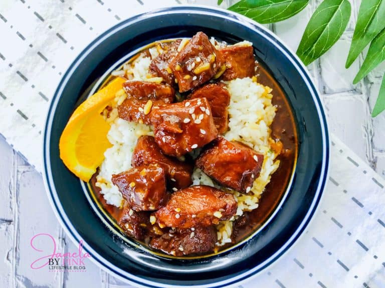bowl of orange chicken over rice